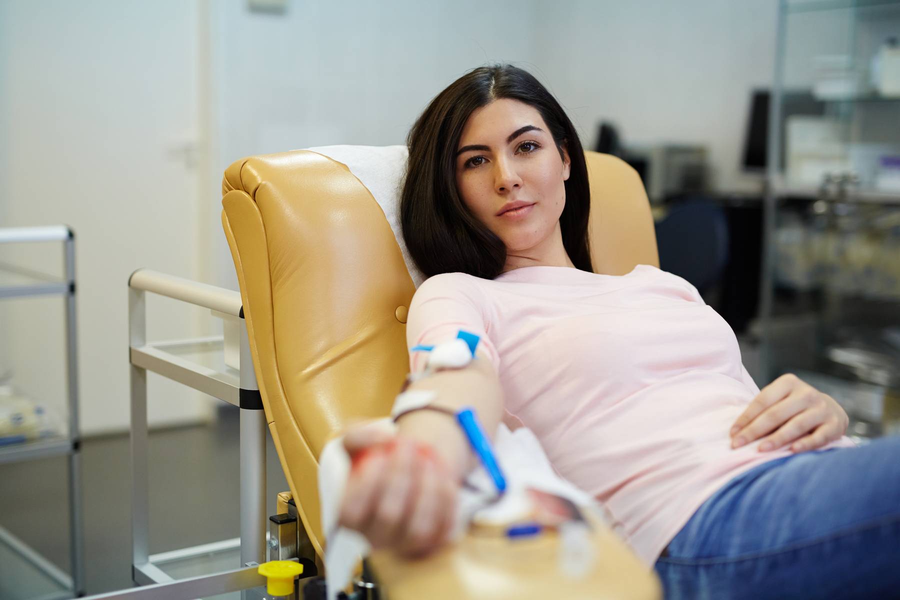 Pretty girl transfusing her blood for sick people